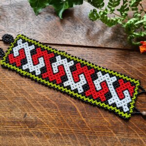 Shipibo red beaded bracelet from the Amazon with Ayahuasca icaro pattern indigenous ceremonial traditional